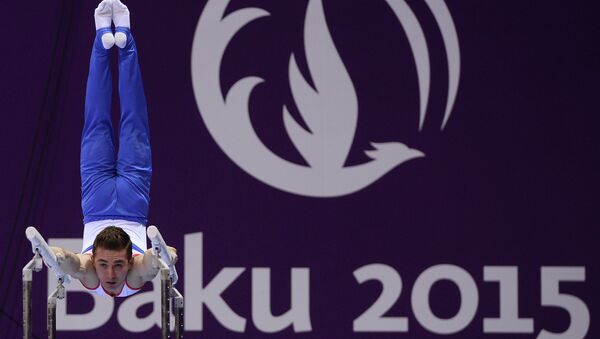 Давид Белявский (Россия) выполняет упражнение на брусьях на I Европейских играх в Баку