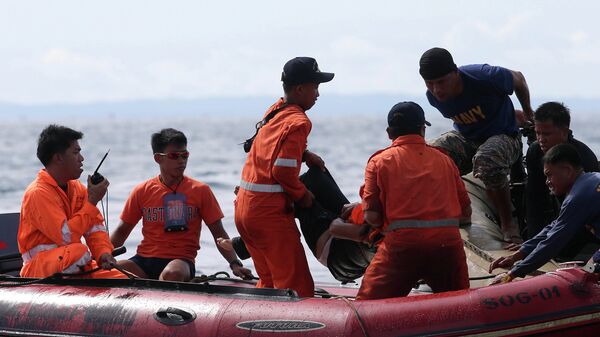Филиппинские спасатели извлекают тело погибшего из воды. Архивное фото