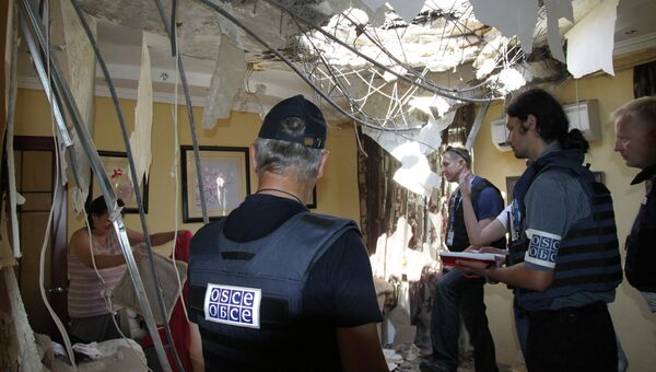 Сотрудники миссии ОБСЕ осматривают квартиру в Донецке, разрушенную в результате обстрела. Архив