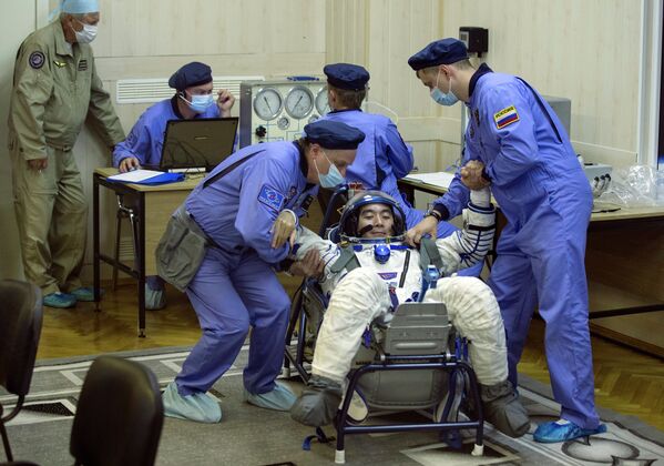 Проверка скафандра астронавта Кимия Юи перед запуском космического корабля Союз ТМА-17М с космодрома Байконур