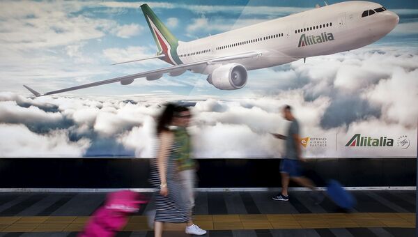 Рекламный плакат авиакомпании Alitalia в международном аэропорту Фьюмичино в Риме. Архив