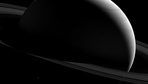 Снимок Сатурна и его спутника Тефии, полученный Кассини