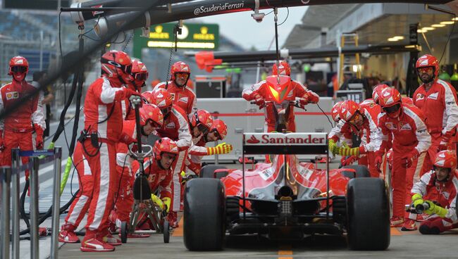 Механики команды Ферарри обслуживают один из болидов команды