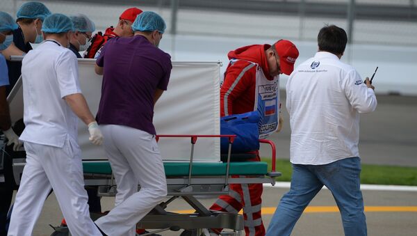 Медики эвакуируют гонщика Торо Россо Карлоса Сайнса-младшего после аварии во время третьей сессии свободных заездов на российском этапе чемпионата мира по кольцевым автогонкам в классе Формула-1.