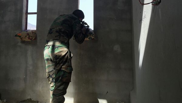 Сирийский военный ведет огонь по позициям боевиков. Архивное фото