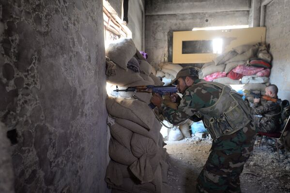 Один из бойцов 4-й дивизии Сирийской Арабской Армии на передовой позиции в пригороде Дамаска Дарайе