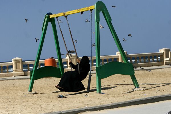 Женщина качается на качелях в парке в Саудовской Аравии