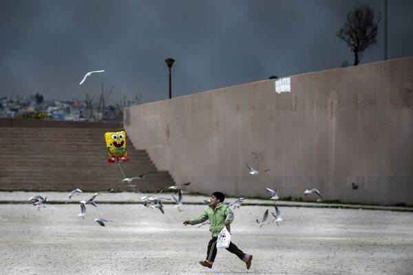 Мальчик бежит у стадиона в Афинах