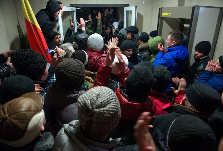 Протестующие и сотрудники правоохранительных органов у здания парламента в Кишиневе