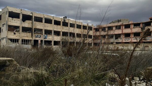 Поврежденное здание в сирийском Хомсе. Архивное фото