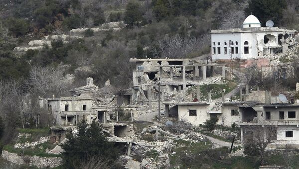 Разрушенные здания в городе Рабия в Сирии