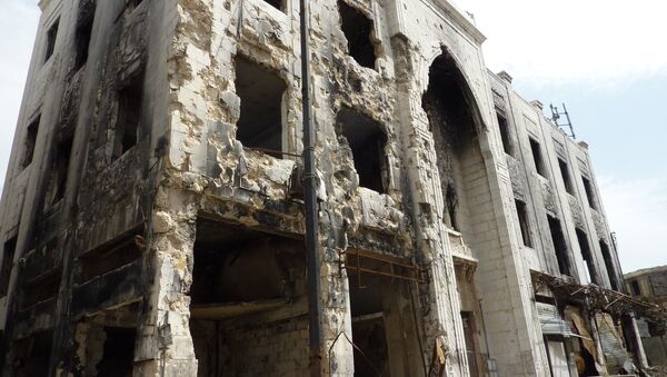 Разрушенное в результате боевых действий здание в городе Хомс