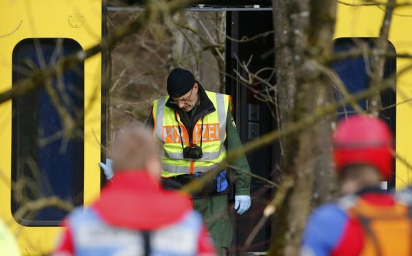 Полицейский фотограф на месте столкновения двух пассажирских поездов в Германии. 9 февраля 2016