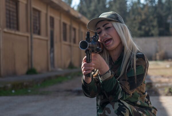 Женщина - доброволец сирийской армии на занятиях в 130-й учебной бригаде в пригороде Дамаска