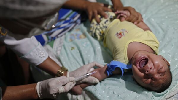 Врач берет кровь у младенца с микроцефалией в Жуан-Песоа, Бразилия. Архивное фото