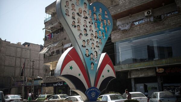 Фотографии погибших жителей Дамаска на одной из улиц города. Архивное фото