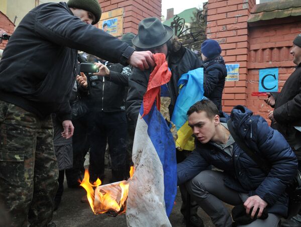 Участники митинга с требованием освободить Н. Савченко сжигают российский флаг, сорванный со здания Генерального консульства РФ во Львове