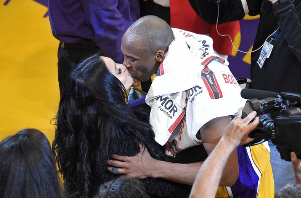Игрок Лос-Анджелес Лейкерс Кобе Брайант целует свою жену Ванессу после матча с Ютой