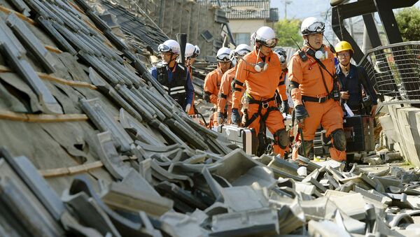 Пожарные среди разрушенных в результате землетрясения зданий. Кумамото, Япония. Апрель 2016