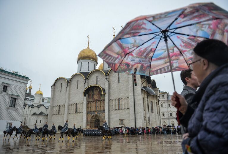 Зрители наблюдают за церемонией развода пеших и конных караулов на Соборной площади Московского Кремля