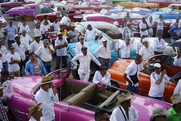 Водители старинных американских автомобилей во время инструктажа по случаю проведения показа круизной коллекции Chanel в Гаване, Куба. Май 2016