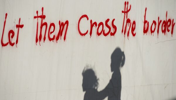 Тень детей на стене лагеря для мигрантов недалеко от греко-македонской границы. Архивное фото