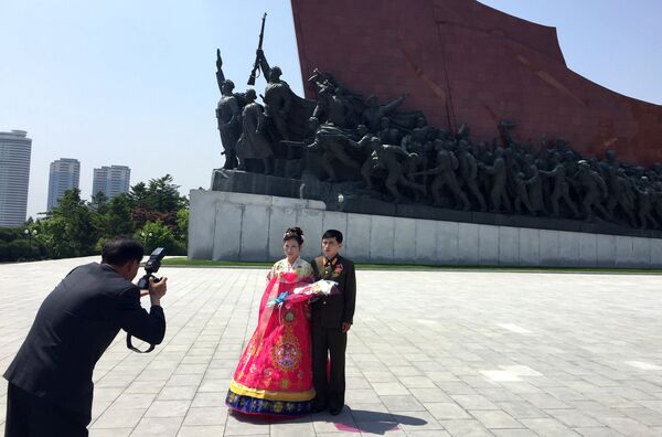 Молодожены по традиции фотографируются на фоне революционных памятников