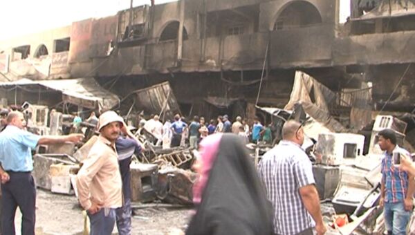 Последствия взрыва в Багдаде: искореженные машины и обгоревшее здание рынка