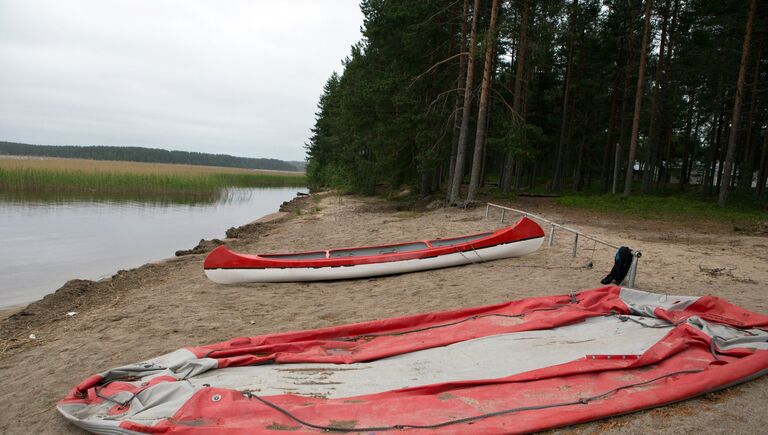 Надувная лодка и байдарка у озера Сямозеро в Карелии, на котором в туристическом походе во время шторма погибли дети.