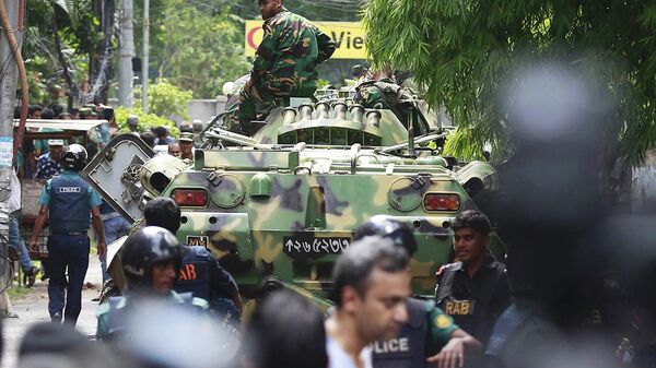 Сотрудники служб безопасности и военные Бангладеша на месте теракта в городе Дакка. Архивное фото
