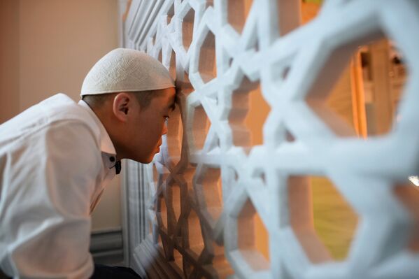 Мусульманин перед намазом в день праздника Ураза-байрам в Соборной мечети в Москве