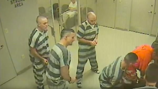 Заключенные оказывают помощь охраннику в суде в штате Техас. Стоп-кадр из видео