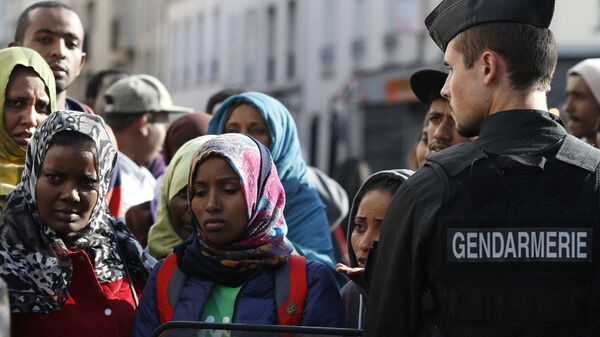 Мигранты и французский полицейский в Париже