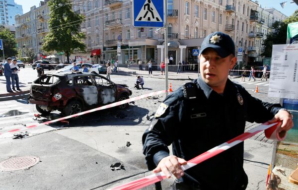 Сотрудник правоохранительных органов на месте взрыва автомобиля, в результате которого погиб журналист Павел Шеремет. Киев, Украина. 20 июля 2016