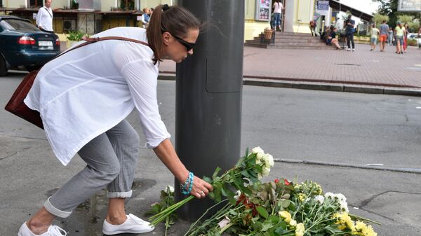 Женщина возлагает цветы к месту гибели журналиста Павла Шеремета. Архивное фото