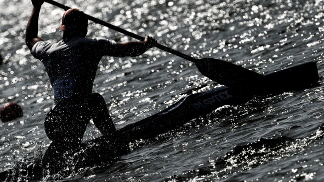 Спортсмен во время заезда по гребле на байдарках и каноэ