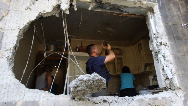 Представитель Специальной мониторинговой миссии ОБСЕ фиксирует разрушения внутри квартиры пятиэтажного дома в Ясиноватой