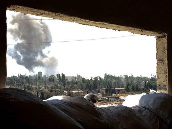 Дым над южным кварталом Рамусе сирийского города Алеппо