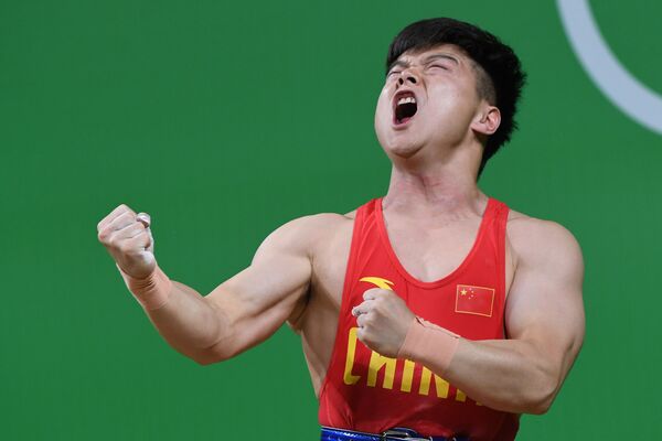 Спортсмен из Китая во время соревнований по тяжелой атлетике на летних Олимпийских играх в Рио-де-Жанейро