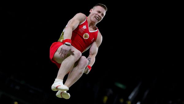 Российский гимнаст Денис Аблязин выполняет опорный прыжок на XXXI летних Олимпийских играх