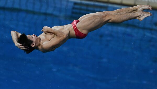 Китайский спортсмен Цао Юань во время финальных соревнований по прыжкам с трамплина 3 м на XXXI летних Олимпийских играх
