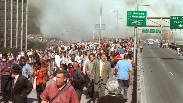 Люди бегут по Бруклинскому мосту после террористической атаки на Всемирный торговый центр в Нью-Йорке. 11 сентября 2001