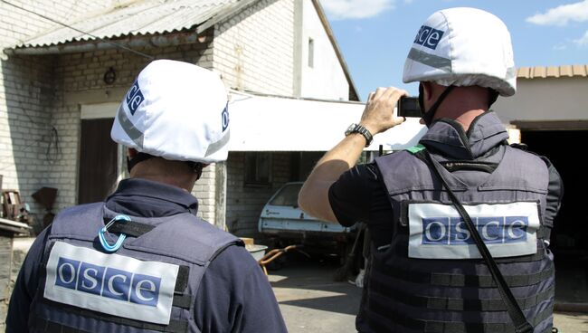 Представители ОБСЕ осматривают повреждения, нанесенные жилому дому в результате обстрела поселка Крутая балка. Архивное фото