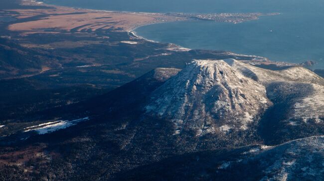 Вид на вулкан Менделеева и поселок Южно-Курильск на острове Кунашир. Архивное фото