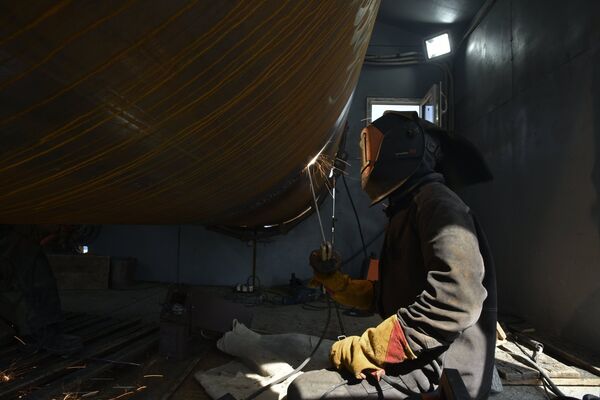 Рабочий сваривает сваю на строительной площадке моста через Керченский пролив в Крыму
