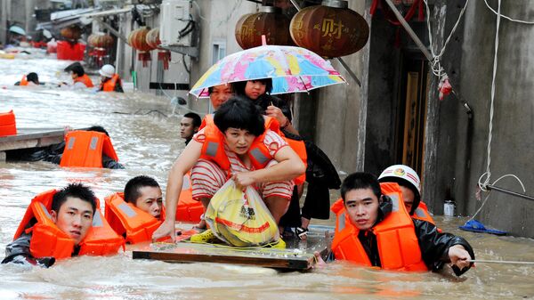 Спасатели эвакуируют жителей из зоны наводнения в Китае