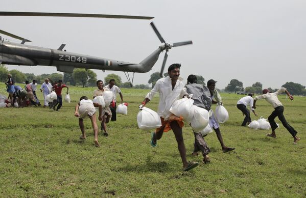 Получение гуманитарной помощи жителями индийской деревни, пострадавшей от наводнения