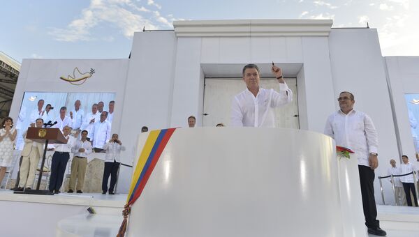 Президент Колумбии Хуан Мануэль Сантос и лидер бывших повстанцев Родриго Лондоньо Эчеверри после подписания соглашения о мире в городе Картахена, Колумбия. 26 сентября 2016