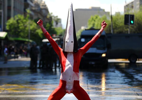 Демонстратор во время акции протеста против Дня Колумба в центре Сантьяго
