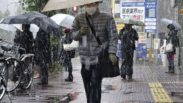 Прохожий во время снегопада в Японии. Архивное фото